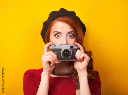 Redhead women with scarf and vintage camera