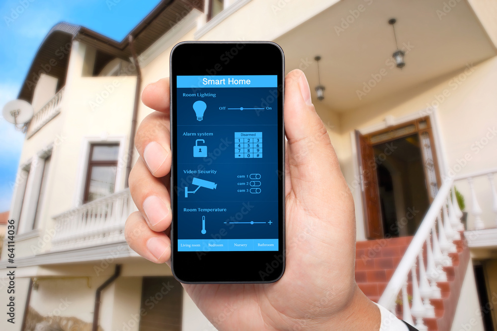 male hand hold a phone with system smart house on the background male hand hold a phone with system smart house on the background