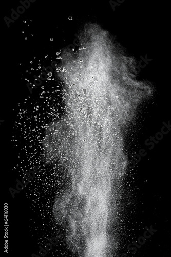 White powder explosion isolated on black