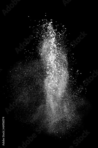 White powder explosion isolated on black