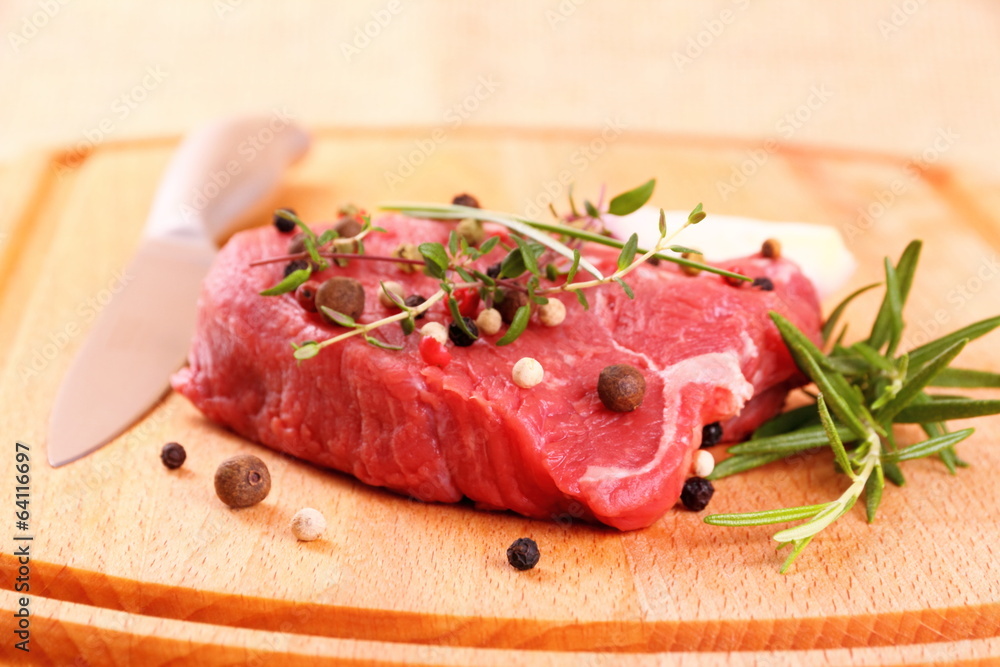 Juicy beef steak with spices, steel knife