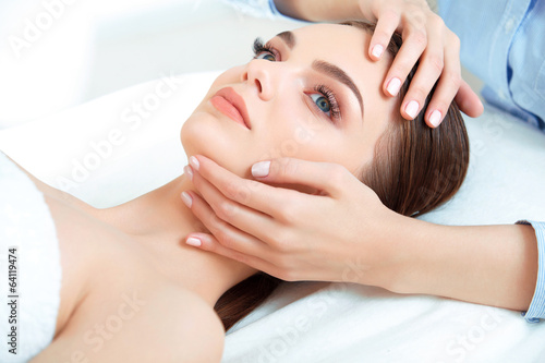 Face Massage. Close-up of a Young Woman Getting Spa Treatment.