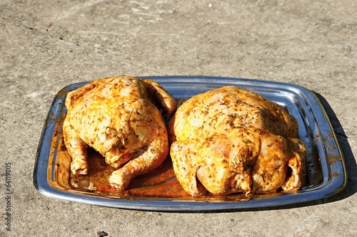 Two roasted chicken on plate photo