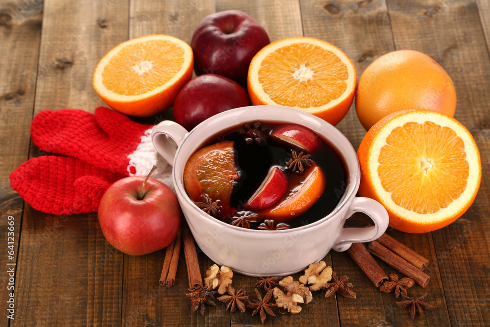 Fragrant mulled wine in pan on wooden table close-up Fragrant mulled wine in pan on wooden table close-up