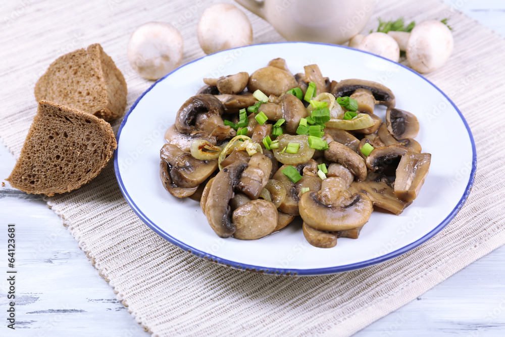 Delicious fried mushrooms on plate on table close-up Delicious fried mushrooms on plate on table close-up