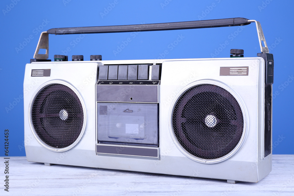 Retro cassette stereo recorder on table on blue background Retro cassette stereo recorder on table on blue background