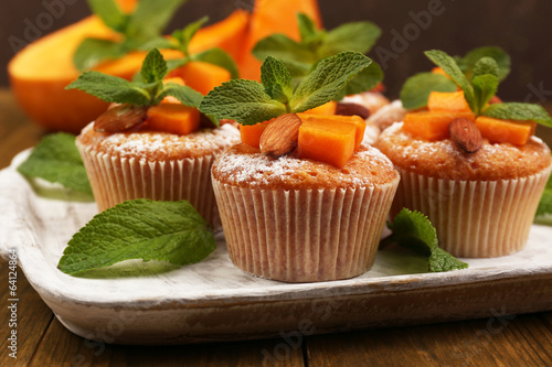 Fototapeta Naklejka Na Ścianę i Meble -  Tasty pumpkin muffins on wooden table