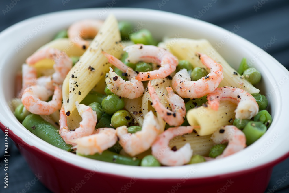 Close-up of penne pasta with shrimps, peas and beans Close-up of penne pasta with shrimps, peas and beans
