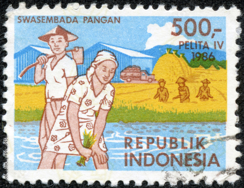 stamp printed in Indonesia shows farmers working at paddy fields