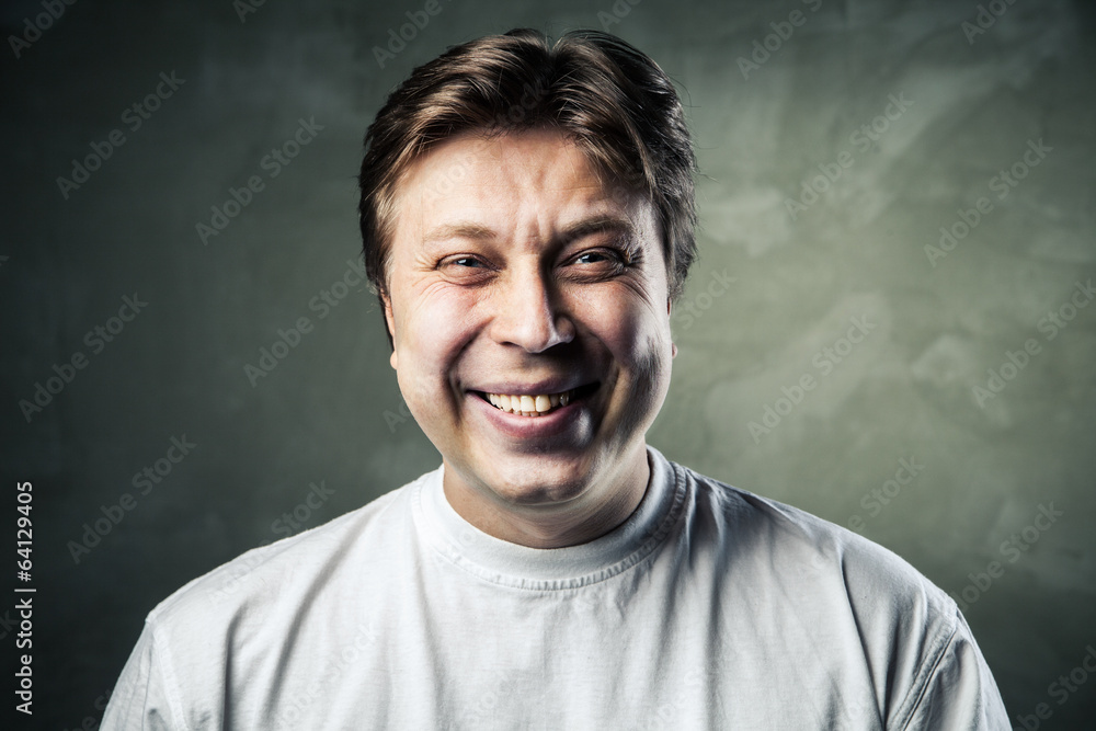 Laughing young man over gray