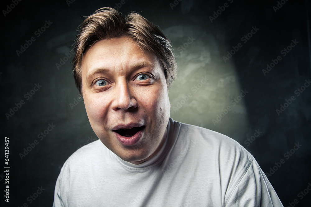 Fototapeta premium Young beautiful man surprised face expression