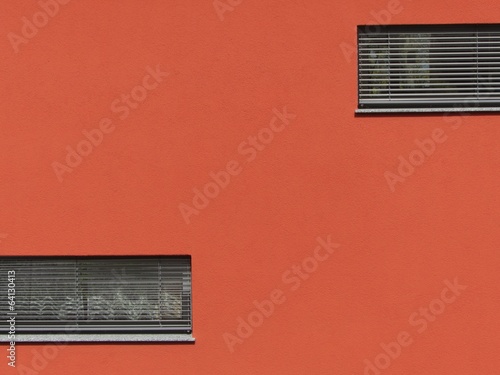 Fassade eines modernen Passivhaus mit Jalousien und Lamellen vor dem Fenster und Fassade in Orange im Dorf Vetzberg bei Rodheim-Bieber in der Gemeinde Biebertal bei Gießen an der Lahn in Hessen photo