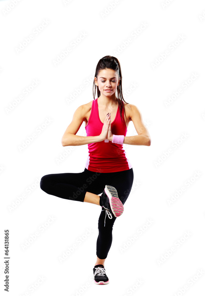 Young sport woman meditated on one leg over white background Young sport woman meditated on one leg over white background
