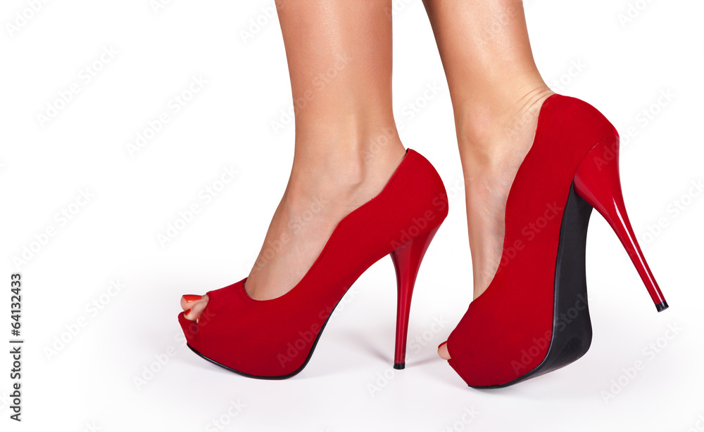 Woman legs wearing red high heels isolated on white background. Woman legs wearing red high heels isolated on white background.