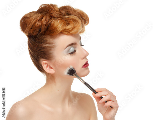 Beauty portrait of pretty woman with brush for makeup