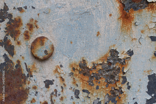 rusty metal surface with cracked paint and a large bolt