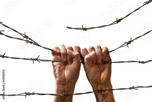 hand behind barbed wire