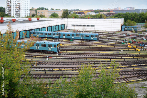 Two city underground trains leave the depot gates photo