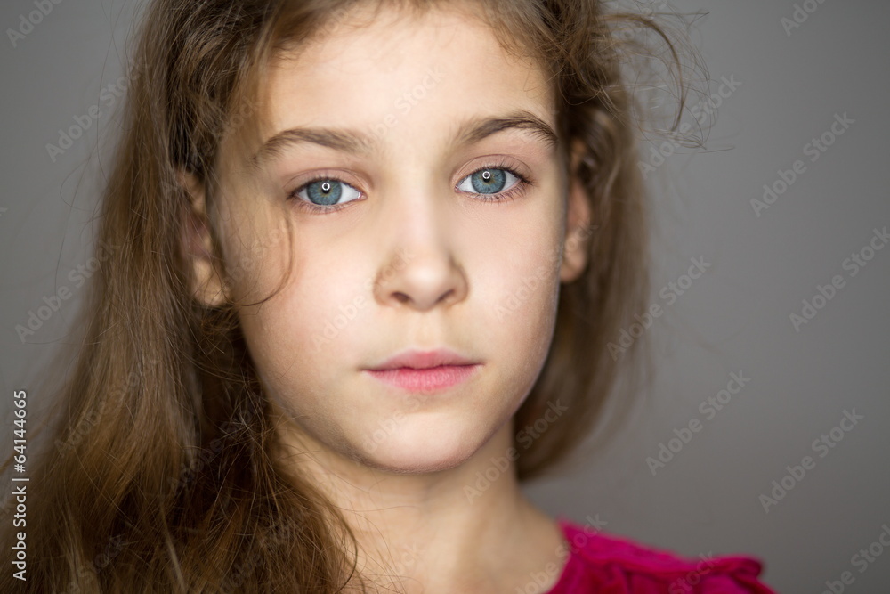 Close-up portrait of little girl in red sweater in studio Close-up portrait of little girl in red sweater in studio