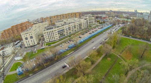 long car parking with plastic cover near residential house