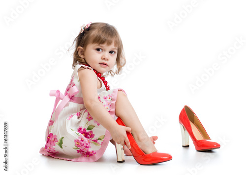 Little girl trying on mummy's shoes
