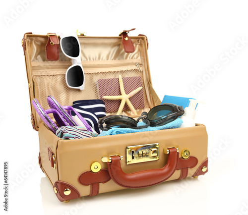Ready to travel open suitcase with summer equipment isolated