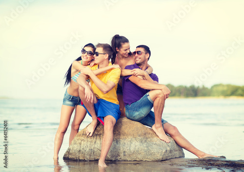 group of friends having fun on the beach