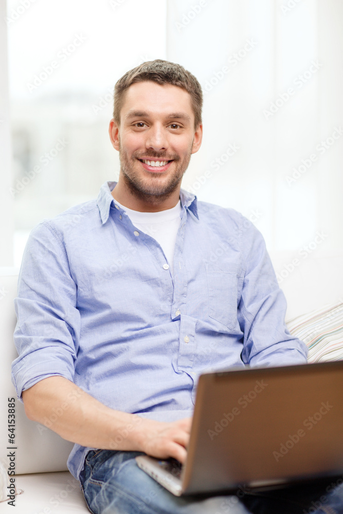 smiling man working with laptop at home smiling man working with laptop at home