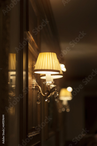 beautiful wall lamp in hotel. Turn on. © timonko