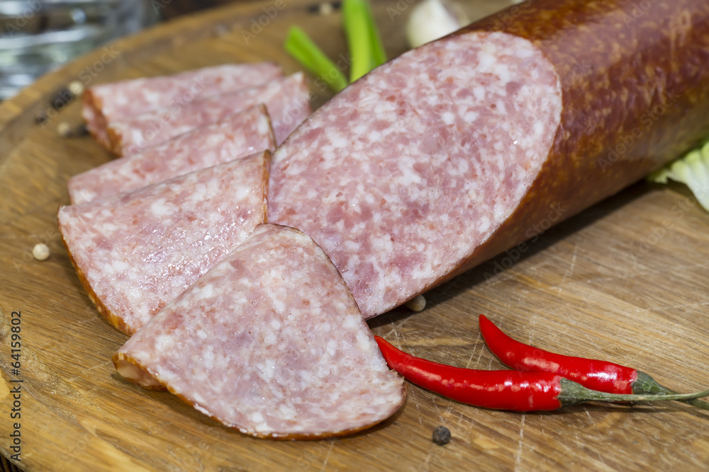 sausage on a wooden plate in a restaurant sausage on a wooden plate in a restaurant
