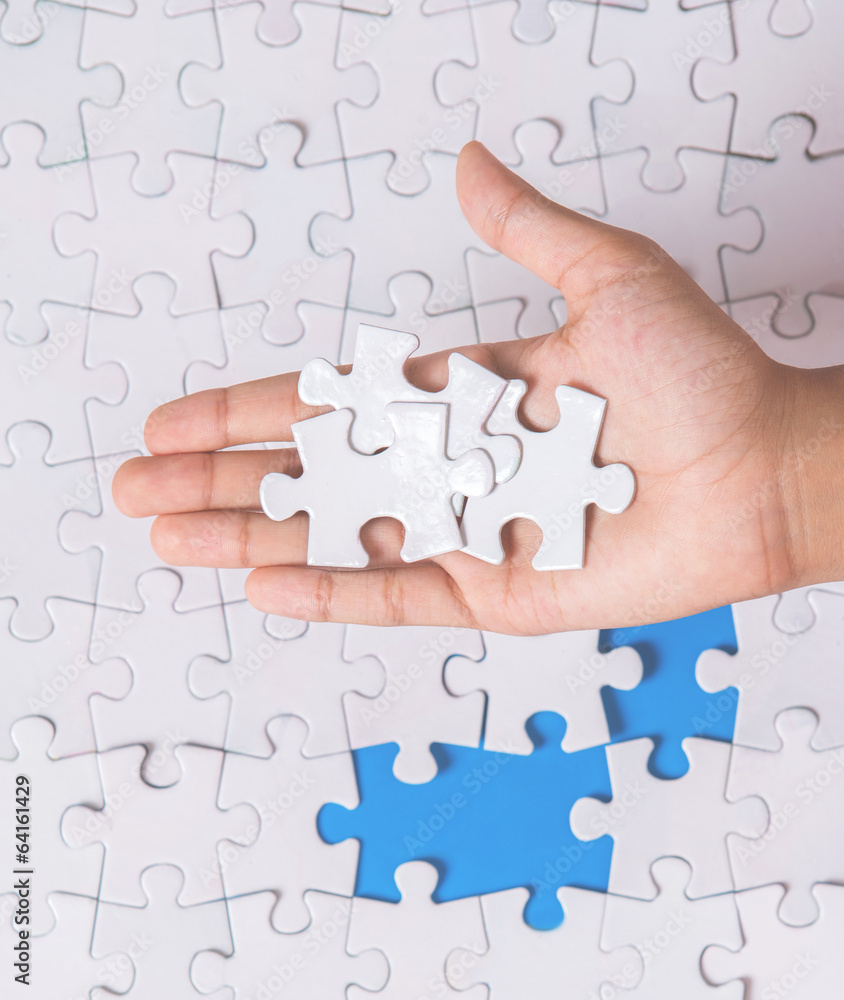 Young girl hand playing jigsaw puzzle Young girl hand playing jigsaw puzzle