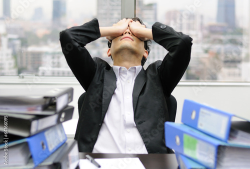Thoughtful or stressful businessman at work