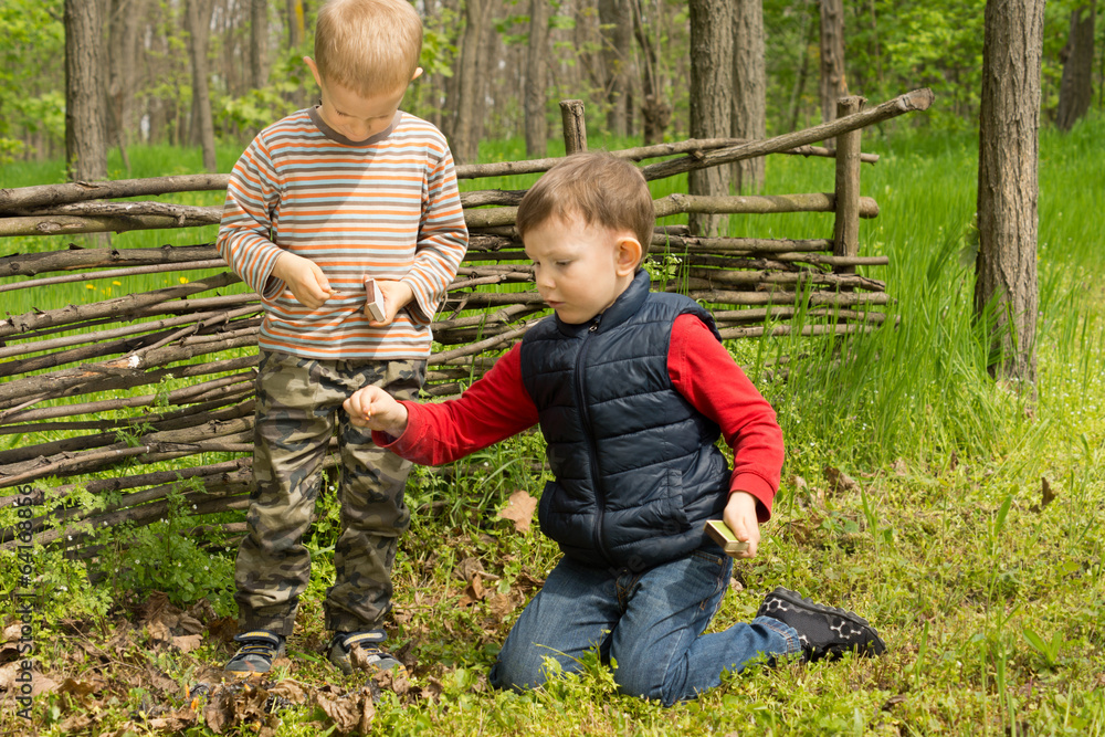 Two young friends playing in woodland Two young friends playing in woodland
