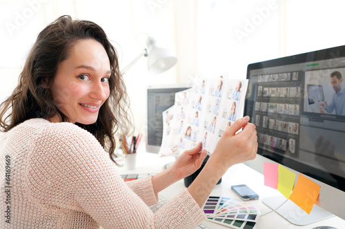 Young woman photographer choosing pictures photo