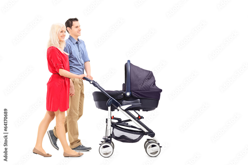 Young parents pushing a baby stroller Young parents pushing a baby stroller