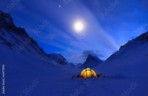 Tent in the mountains on a winter night in Lapland.