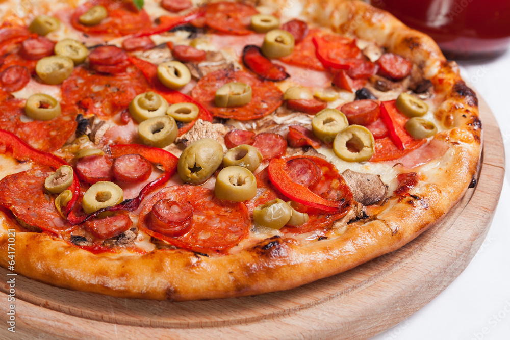 Pizza with mozzarella, ham and olives