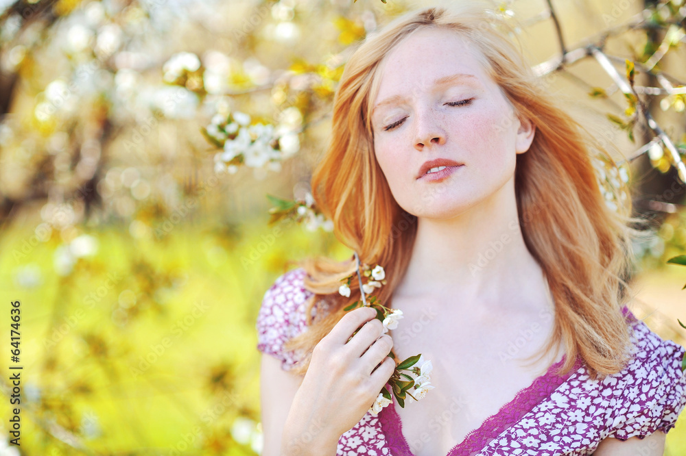 Fototapeta premium Beautiful healthy young girl in blooming tree. Eyes closed
