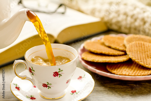 Tea being poured into china teacup