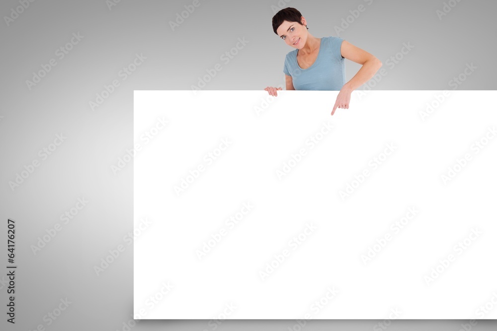Composite image of pretty brunette showing card Composite image of pretty brunette showing card