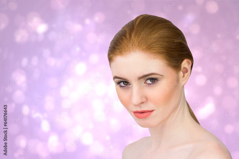 Composite image of beautiful redhead looking at camera Composite image of beautiful redhead looking at camera