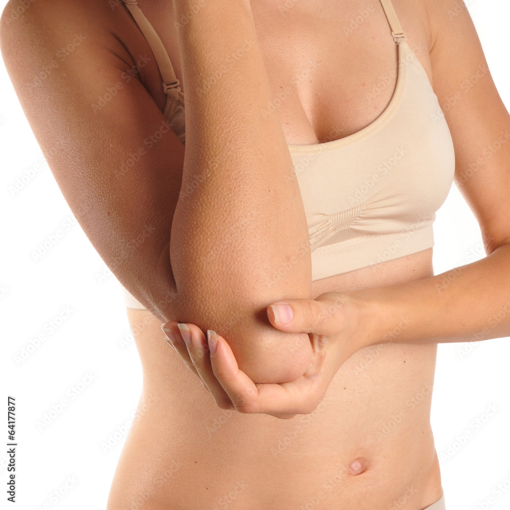 Female holding hand to spot of elbow pain.