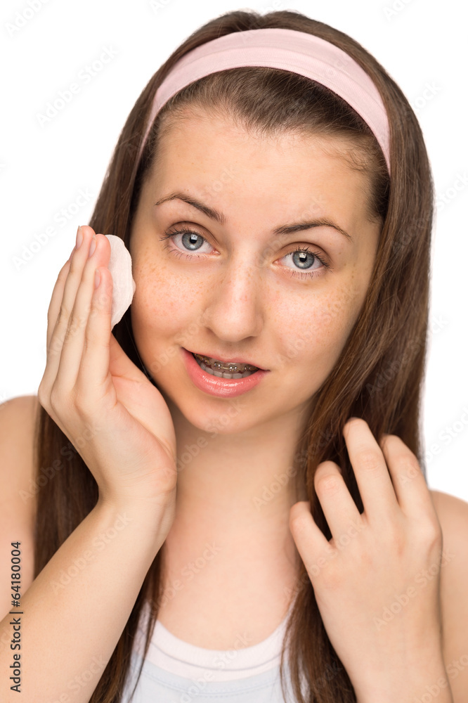 Girl cleaning face with cotton pad isolated Girl cleaning face with cotton pad isolated