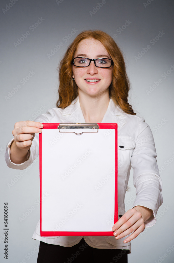 Naklejka premium Businesswoman with notepad in the studio