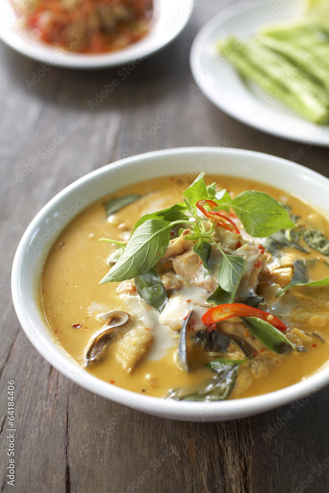 spicy fish curry with chili and coconut sauce on table spicy fish curry with chili and coconut sauce on table