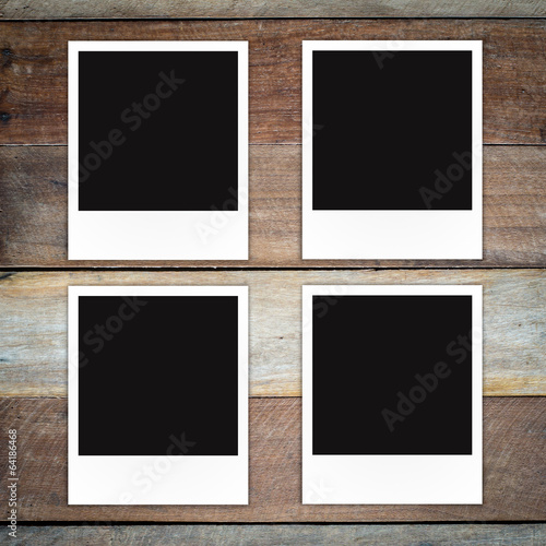 Polaroid photo frame on wood background