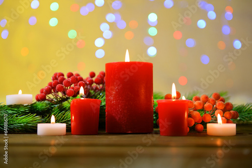 Candles and Christmas decoration on bright background