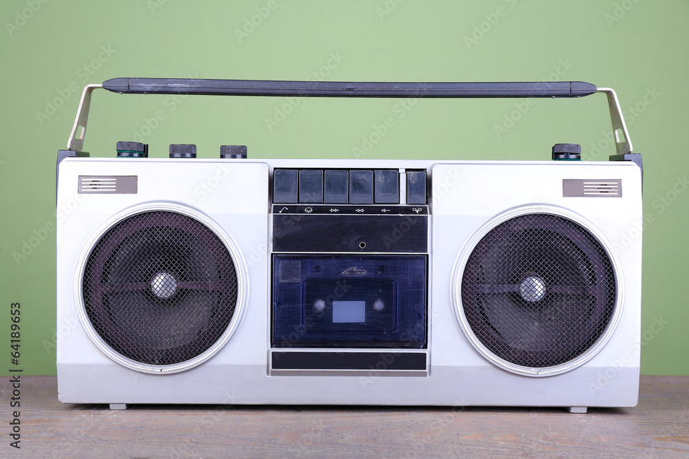 Retro cassette stereo recorder on table on green background Retro cassette stereo recorder on table on green background