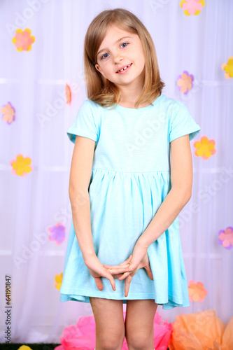 Beautiful small girl on decorative background