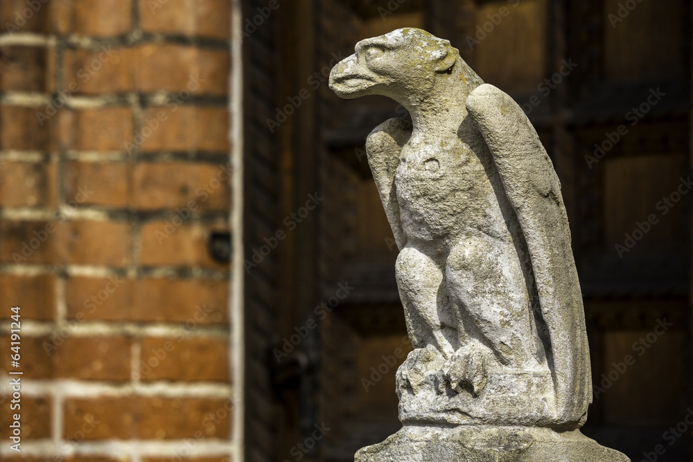 sculpture of a mythical bird at the entrance of a building